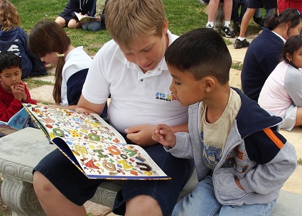 Student volunteers often read with students at the recipient schools or programs.